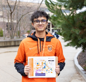 Student showing map of campus